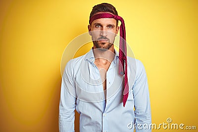 Hangover business man drunk and crazy for hangover wearing tie on head with serious expression on face Stock Photo