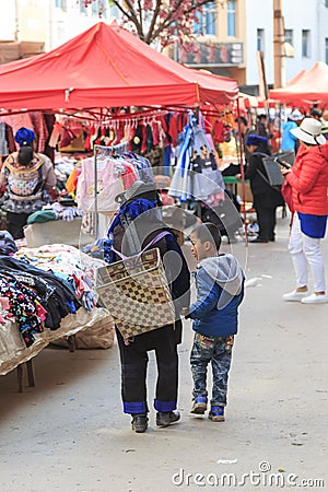 Hani people buying stuff in the Shengcun local market in YuanYang. Hani are one of the 56 minorities in China and are native of Yu Editorial Stock Photo