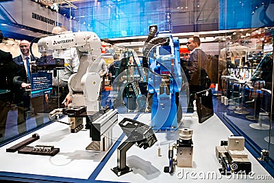 Mitsubishi and Yaskawa robot arms on Schunk stand on Messe fair in Hannover, Germany Editorial Stock Photo