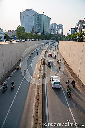 Hanoi traffic with vehicles running on Dai Co Viet crossing underpass tunnel exit Stock Photo