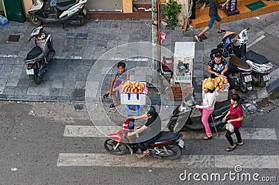 Street food vendors selling bread rolls on sidestreet in Hanoi Editorial Stock Photo