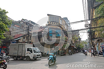 Hanoi, Vietnam - Busy street corner in old town during day time December 23, 2018 Hanoi Vietnam. Most vehicles on the roads of Vie Editorial Stock Photo