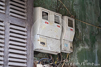 Hanoi, Vietnam - Feb 28, 2016: Electric meters hanging on wall of a house in Hanoi. Electric supply is still a big matter in the c Editorial Stock Photo