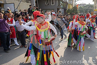 Hanoi, Vietnam - Feb 5, 2017: Men with women dress performing ancient dance called Con Di Danh Bong - Prostitutes beat the drum at Editorial Stock Photo