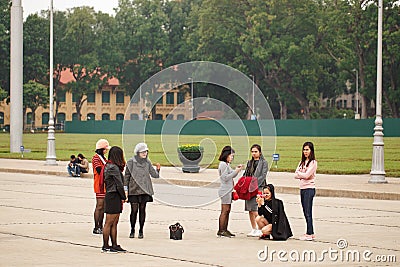 Hanoi, Vietnam, July 13, 2018, girls walk and take pictures in a central square Editorial Stock Photo