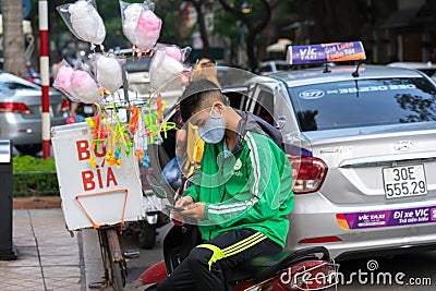 Hanoi, Vietnam - July 7, 2017: Grab motorbike driver waiting for customer on Ba Trieu street. Entered Vietnam in 2014, Grab growin Editorial Stock Photo