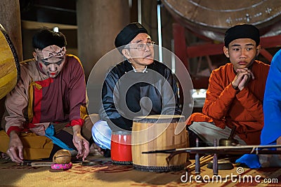 Hanoi, Vietnam - Jun 22, 2017: Band of Traditional folk singers in communal house at So village, Quoc Oai district. Editorial Stock Photo