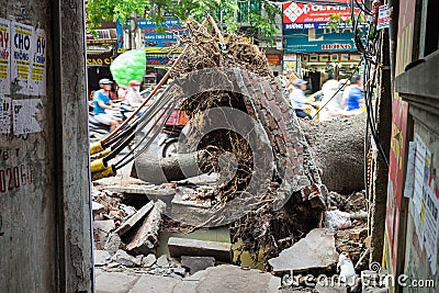 Hanoi, Vietnam - June 14, 2015: Fallen tree damaged on street by natural heavy wind storm in Minh Khai street Editorial Stock Photo