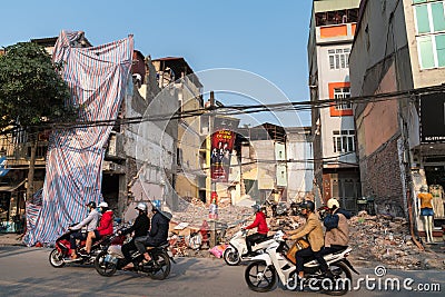 Hanoi, Vietnam - Mar 10, 2018: Urban resident houses are dismantled and demolished by machine. Land cleanrance progress to widen Editorial Stock Photo