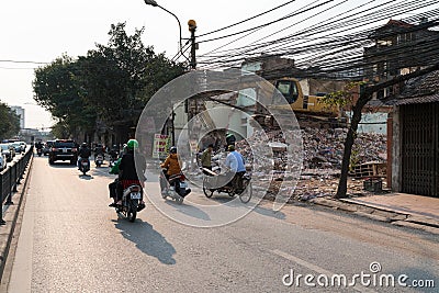 Hanoi, Vietnam - Mar 10, 2018: Urban resident houses are dismantled and demolished by machine. Land cleanrance progress to widen Editorial Stock Photo