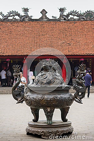 A Big antique bronze incense burner with tourist background in the House of Ceremonies at Temple of Literature Original built in Editorial Stock Photo