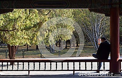 Hanoi, Vietnam, March 30th 2019 : An unidentified man relaxes on a bench Editorial Stock Photo