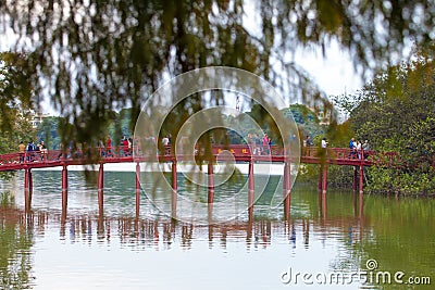 Hanoi, Vietnam - October 21, 2019 : Hanoi red bridge. The wooden red painted bridge over the Hoan Kiem Lake connects the shore and Editorial Stock Photo