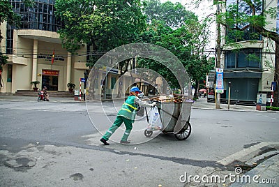 HANOI, VIETNAM - 3rd Febnuary, 2014: Workers collecting garbage on the streets of Hanoi, Vietnam Editorial Stock Photo