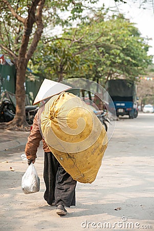 HANOI, VIETNAM - 19th January, 2014, The poor woman return home after a day of labor. Editorial Stock Photo