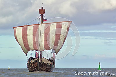 Hanseatic cog under sail with green and yellow buoy Stock Photo