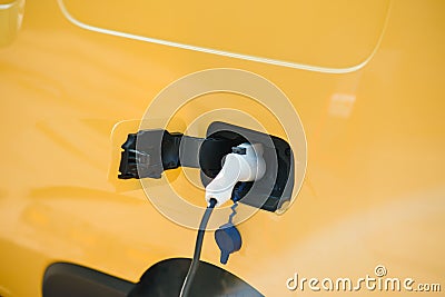 Hansome bearded guy near his new modern electric car at the charging station Stock Photo