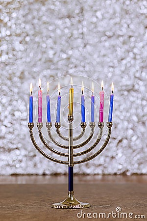 During Hanukkah celebration, candlelight lights up Hanukkah Menorah symbolizing Jewish religion holiday Stock Photo