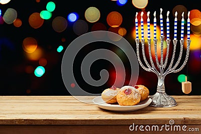 Hanukkah holiday sufganiyot with menorah on wooden table Stock Photo