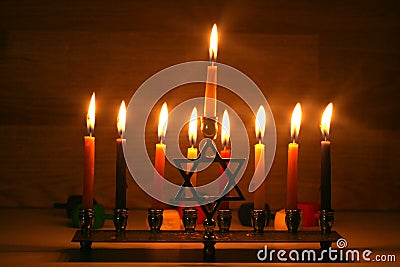 Hanukkah is a Jewish holiday. Burning Chanukah candlestick with candles. Chanukiah Menorah Stock Photo