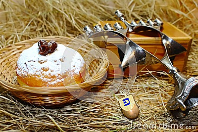 Hanukkah symbols: doughnut Sufganiyah or Sufganiyot, spinning top Dreidel and Menorah. Hanukkah - Jewish holiday in Israel Stock Photo