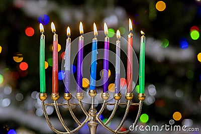 Hanukkiah Menorah with burned candles on blurred bokeh in the Jewish holiday symbol for Hanukkah Stock Photo