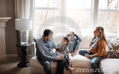 The happiest family around. two adorable little boys having fun with their parents at home. Stock Photo