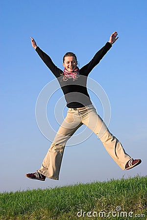 Happily jumping fit attractive woman Stock Photo