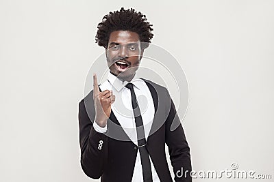 Happiness afro man looking at camera with idea finger. Stock Photo