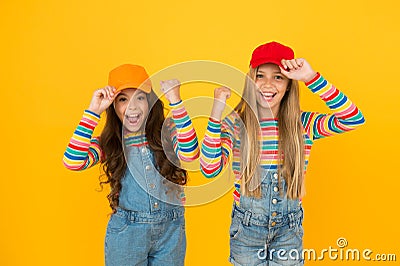 Happiness ahead. Happy small girls enjoying happiness together on yellow background. Little kids with cute smiles Stock Photo