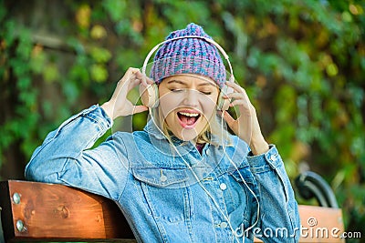 Happiness. audio book. style and music. hipster woman in headphones. modern technology instead of reading. relax in park Stock Photo