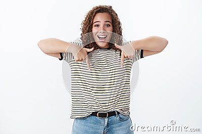 Happiness, diversity body-positivity concept. Gorgeous chubby smiling happy woman lively grinning pointing down index Stock Photo