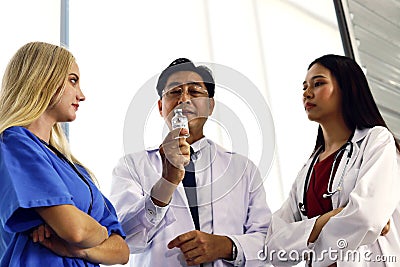 Happiness doctor teamwork holding corona virus vaccine for use in clinic or hospital room. Stock Photo