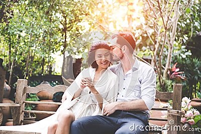 Happiness and romantic scene of love asian couples partners making eye contact and kiss Stock Photo