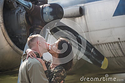 Happiness is traveling. woman and handsome man enjoy summer romance. Couple in love kiss at airplane. Loving couple Stock Photo