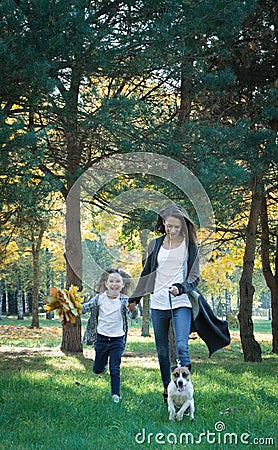 Happy abstract: mother and daughter run in city park Stock Photo