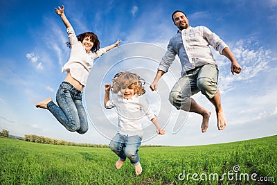 Happy active family jumping Stock Photo