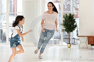 Happy mom and kid daughter playing tag and touch game Stock Photo