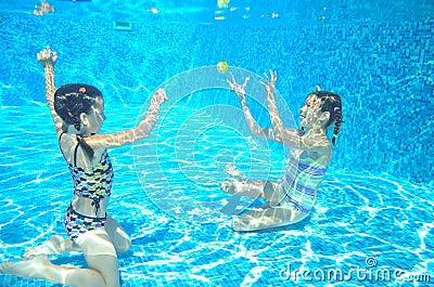 Happy active kids swim in pool and play underwater Stock Photo