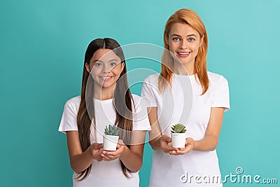 Happy adoptive family of adopted daughter child and woman mother smile holding houseplants, adoption Stock Photo