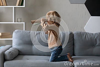Happy adorable small boy playing alone at home. Stock Photo