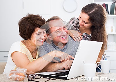 Happy adult daughter showing documents to her parents Stock Photo