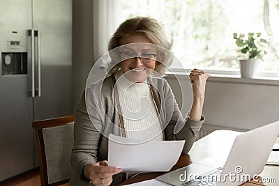 Happy adult retiree woman reading bank document Stock Photo