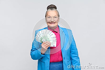 Happy adult woman holding many euro Stock Photo