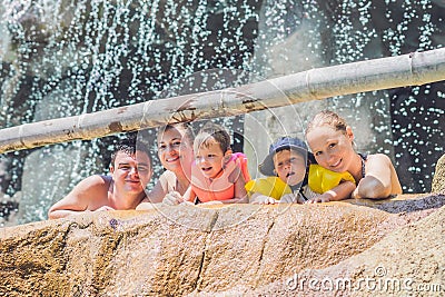 Happy adults and children in a water park Stock Photo