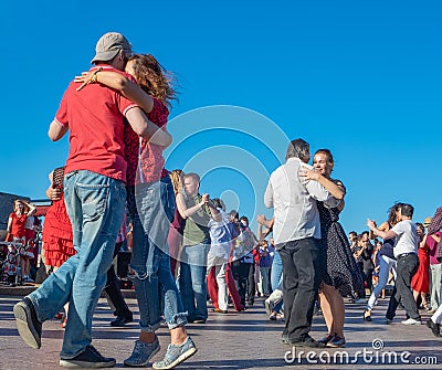 Happy adults are dancing tango or waltz on the city street Editorial Stock Photo