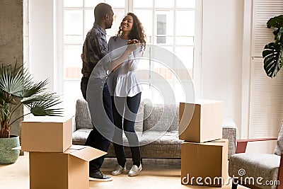 Happy African American couple dancing after moving Stock Photo