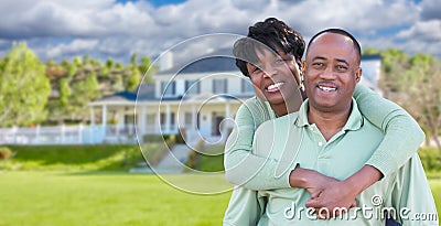 Happy African American Couple In Front of Beautiful House. Stock Photo