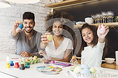 Happy African American family coloring eggs Stock Photo