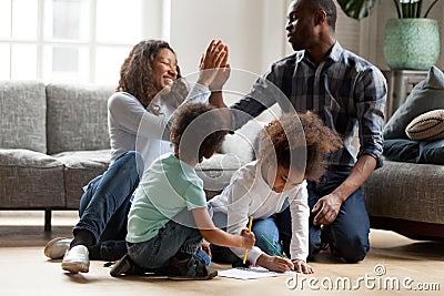 Happy African American family playing together indoors Stock Photo